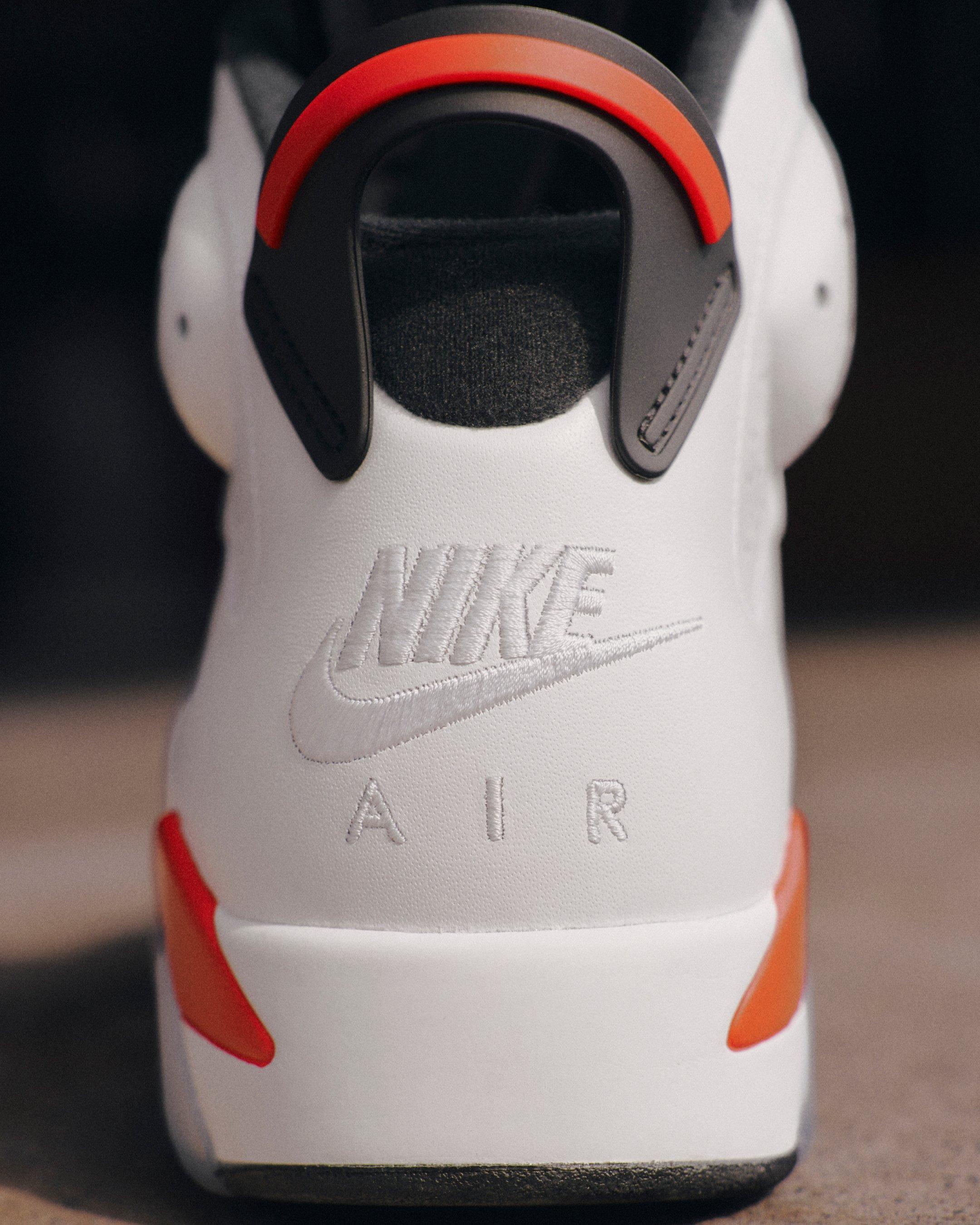 Close-up of the Jordan 6 Retro White Infrared heel featuring embroidered white Nike Air branding, a black pull tab and infrared accents.