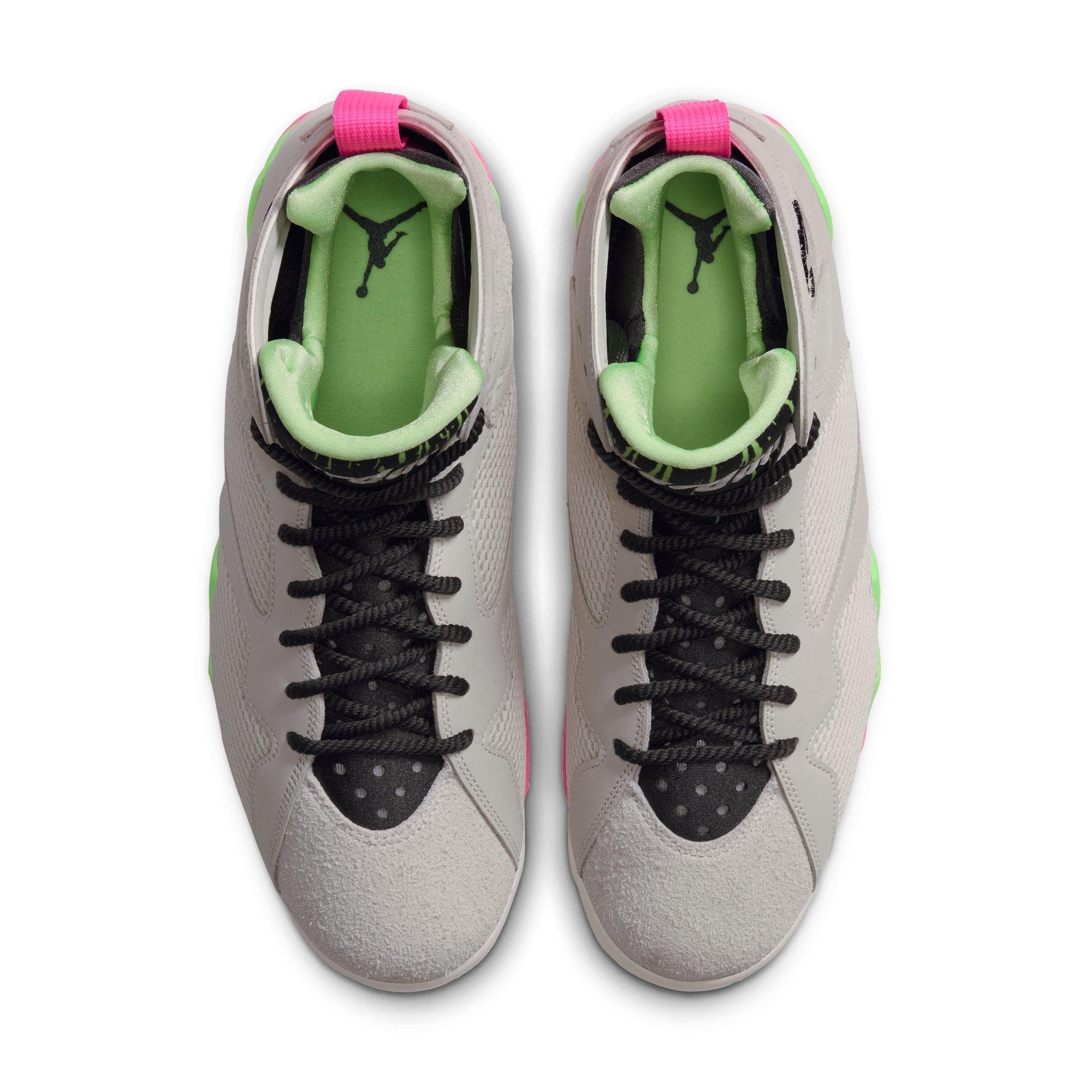 Top view of Air Jordan 7 Retro &ldquo;Tennis Day&rdquo; sneakers featuring black laces, gray suede toe panels, green lining and bright pink heel pull tabs.