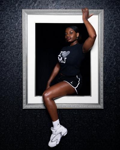 Black basketball graphic tee with black athletic shorts and white basketball sneakers