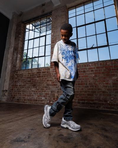 Boy modeling Saucony sneakers