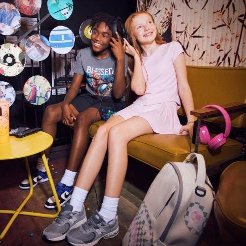 Kids on couch listening to music and eating candy