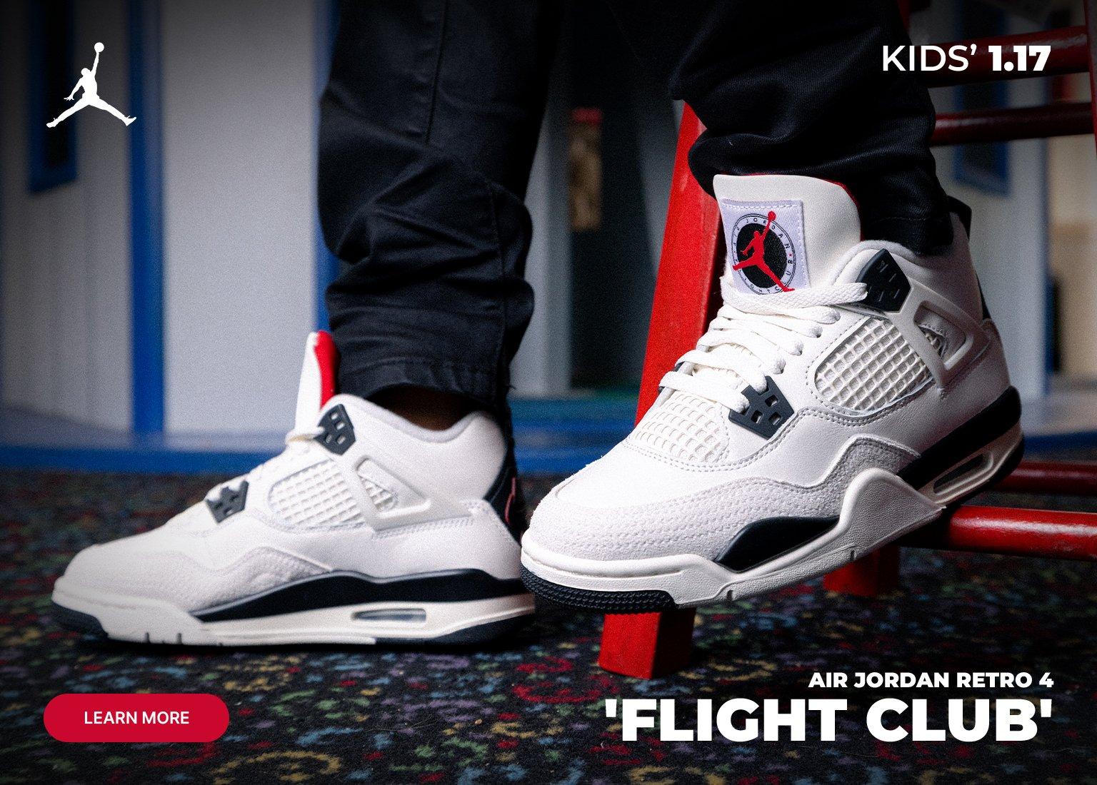 An advertisement for the Air Jordan Retro 4 'Flight Club' featuring a young boy wearing a red graphic T-shirt and black pants. He is sitting in a colorful play area with a hot air balloon mural. The right side of the image shows a close-up shot of the white, black, and red sneakers. The text includes the Jordan logo, the release date "KIDS' 1.17," and a "LEARN MORE" button.