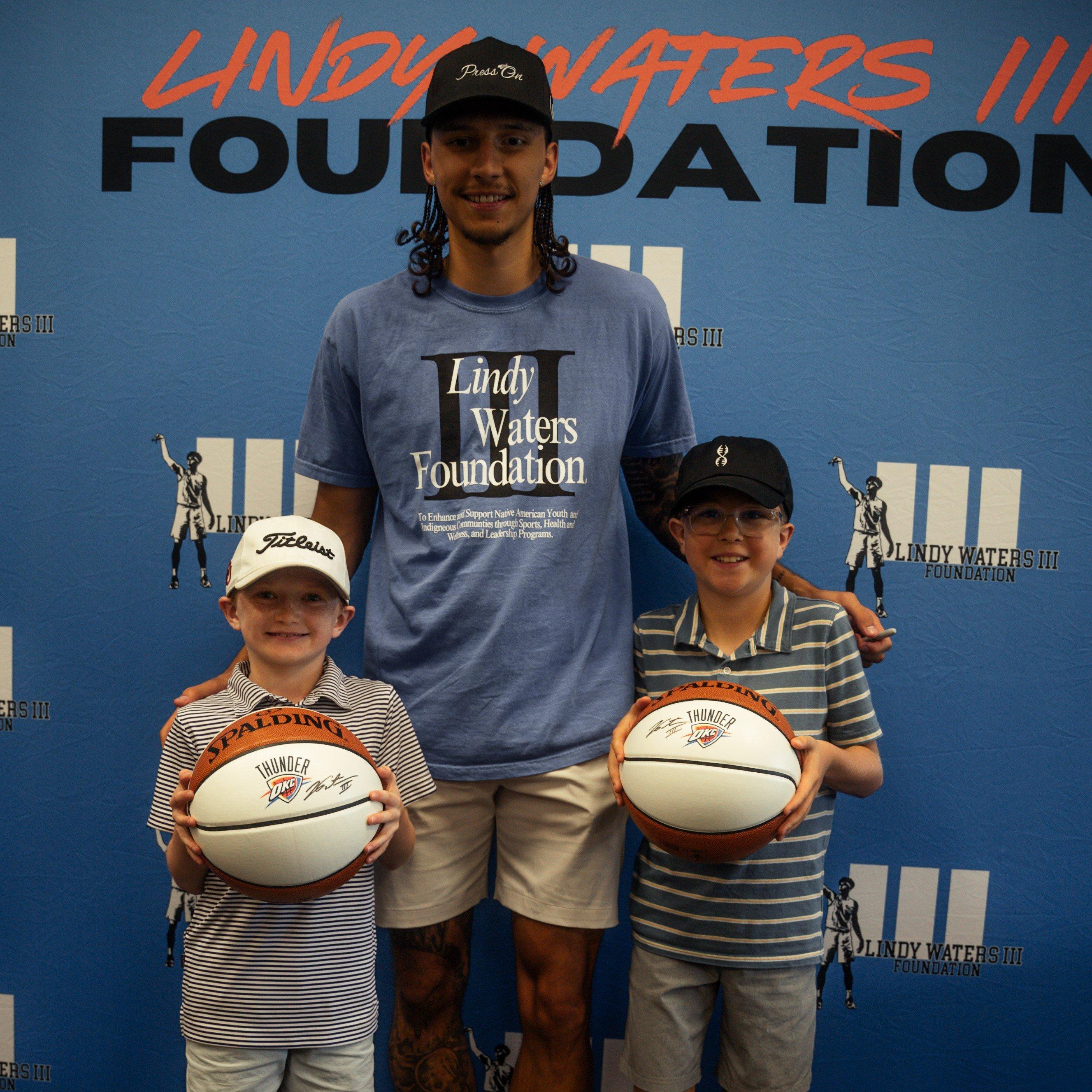 lindy-posing-with-kids-holding-signed-okc-basketballs