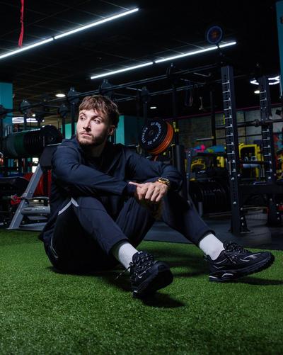 Guy sitting in Under Armour apparel