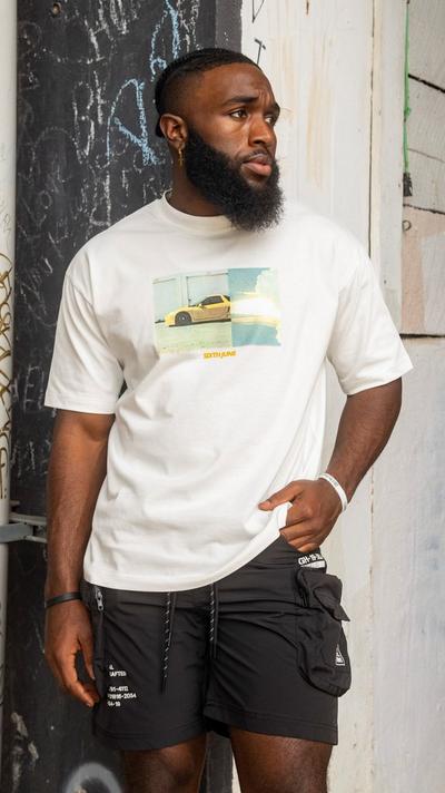 Man in alley wearing Sixth June's Foreign Tee in off white