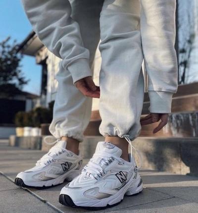 Woman wearing white New Balance 530s
