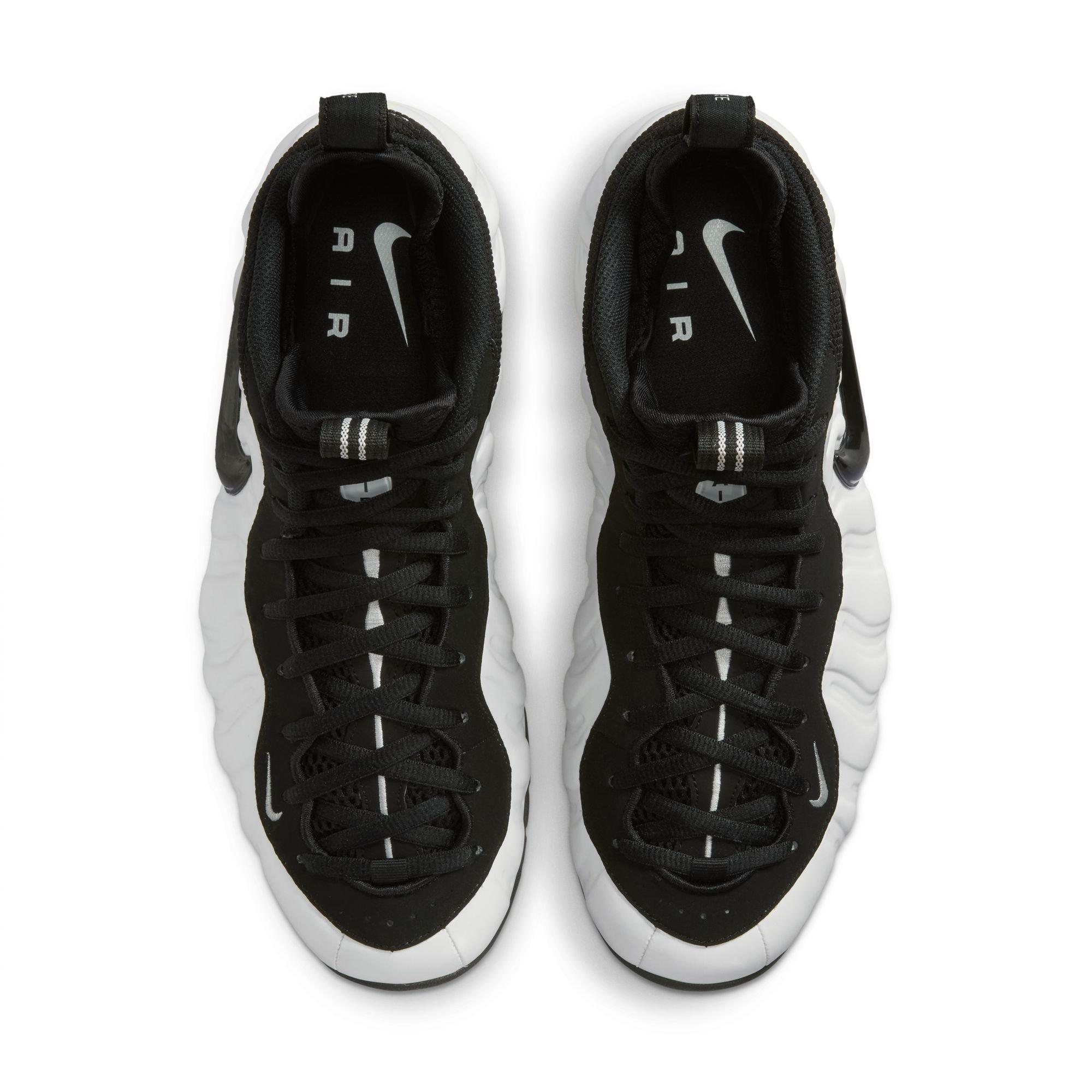 Top view of Nike Air Foamposite Pro Premium sneakers featuring black laces, black uppers, white center stripes and Nike Air insoles.