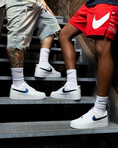 Men in Nike Air Force 1 '07 LV8 "World Cup USA" and Nike soccer apparel