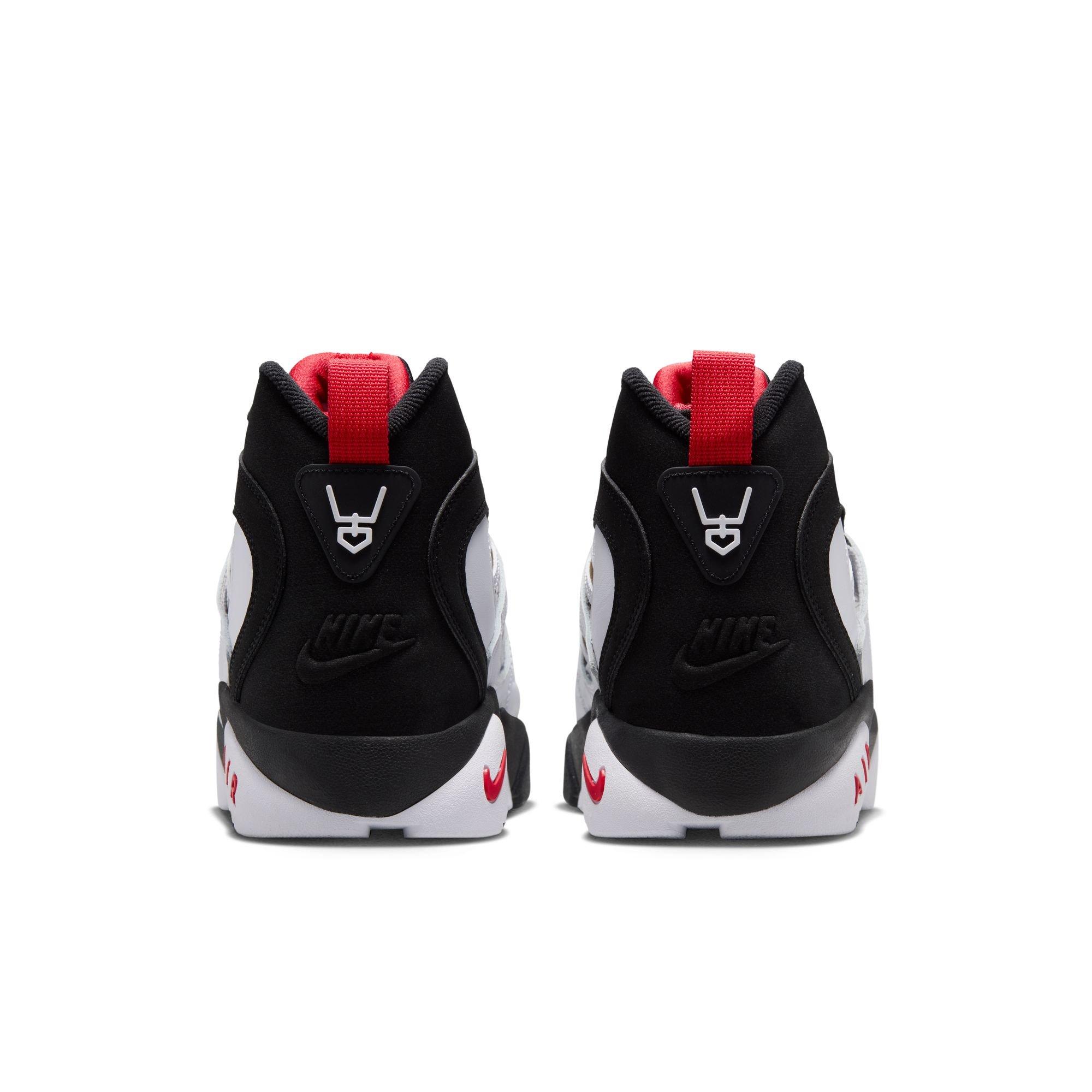 Rear view of Nike Air Diamond Turf II sneakers featuring black heels, red pull tabs, white Nike branding and black-and-white midsoles.