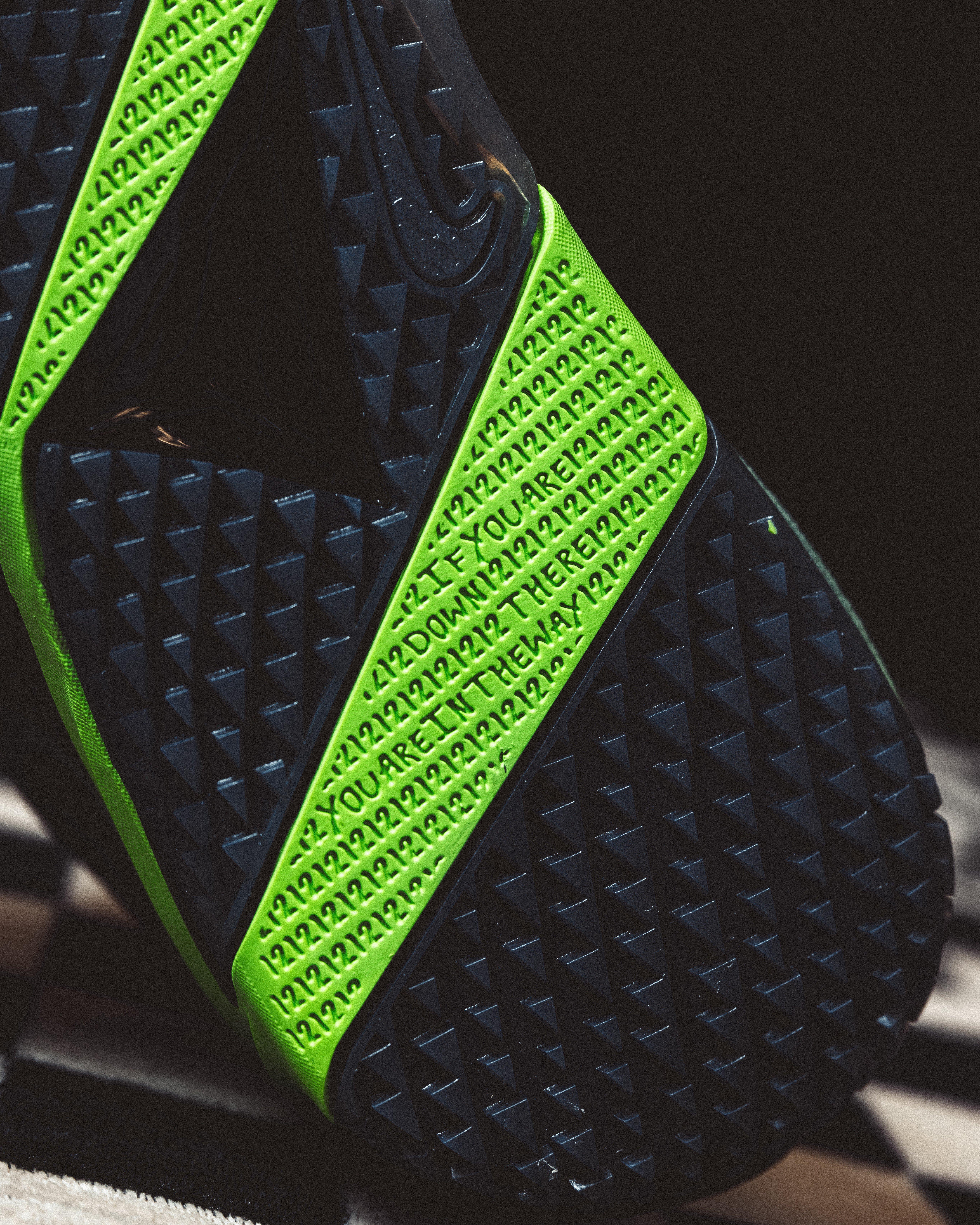 Bottom view of the Nike Ja 4 Nightmare basketball shoe featuring a black traction outsole with neon green panels and repeating &ldquo;12&rdquo; and &ldquo;You Aren&rsquo;t Down There Anyway&rdquo; text.