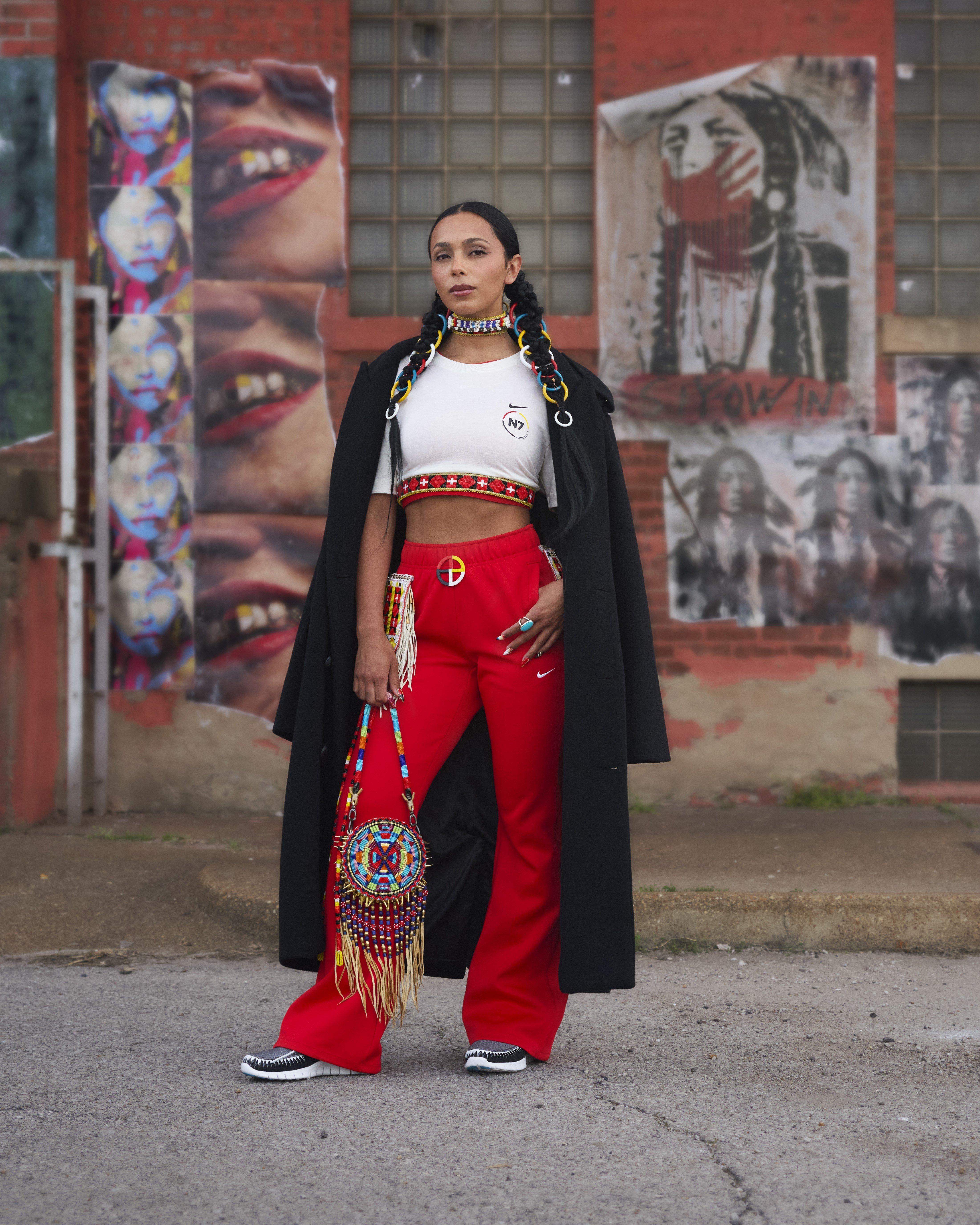 Women in Nike N7 Shirt, Nike Red Pants, and Nike Free Forward Moc N7 "Black"