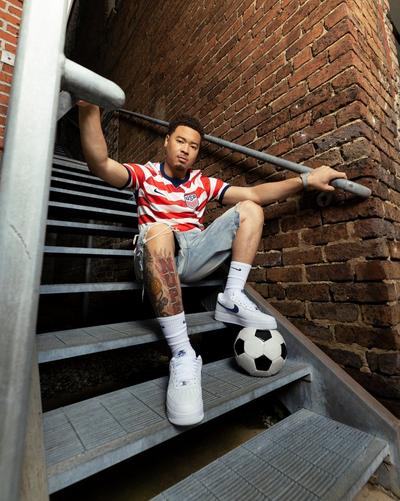 Man in Nike USA FIFA World Cup 2026 Home Jersey, denim shorts, and Nike Air Force 1s