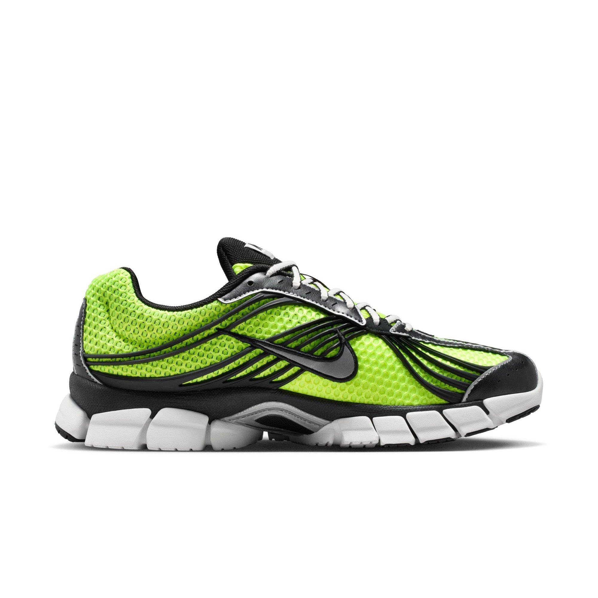 Close-up of the Nike Zoom Skylon 11 Volt sneaker showing white laces, black overlays, bright green mesh and a black Nike Swoosh.