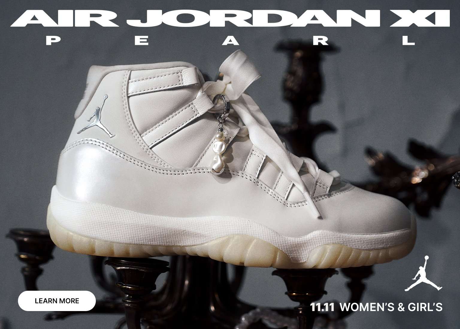 Air Jordan XI Pearl sneaker, featuring a close-up of the white, high-top shoe with a pearl charm, surrounded by images of people wearing the shoe and the text WOMEN'S & GIRL'S and 11.11.