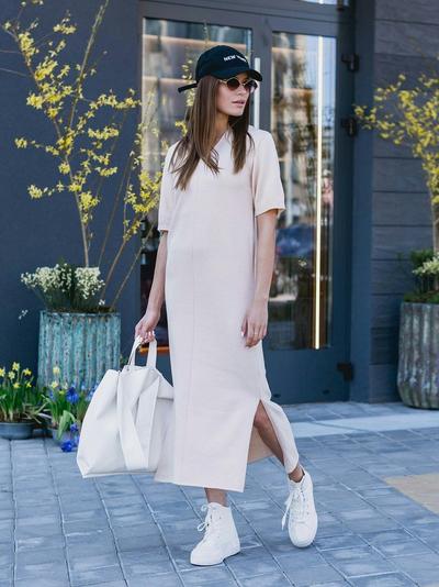 Woman in white dress and white sneakers
