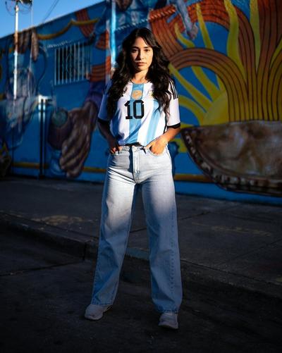 Young woman in blue and white striped jersey and jeans.