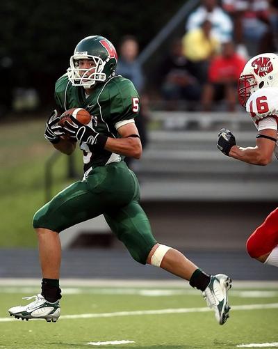 Football player running on football field