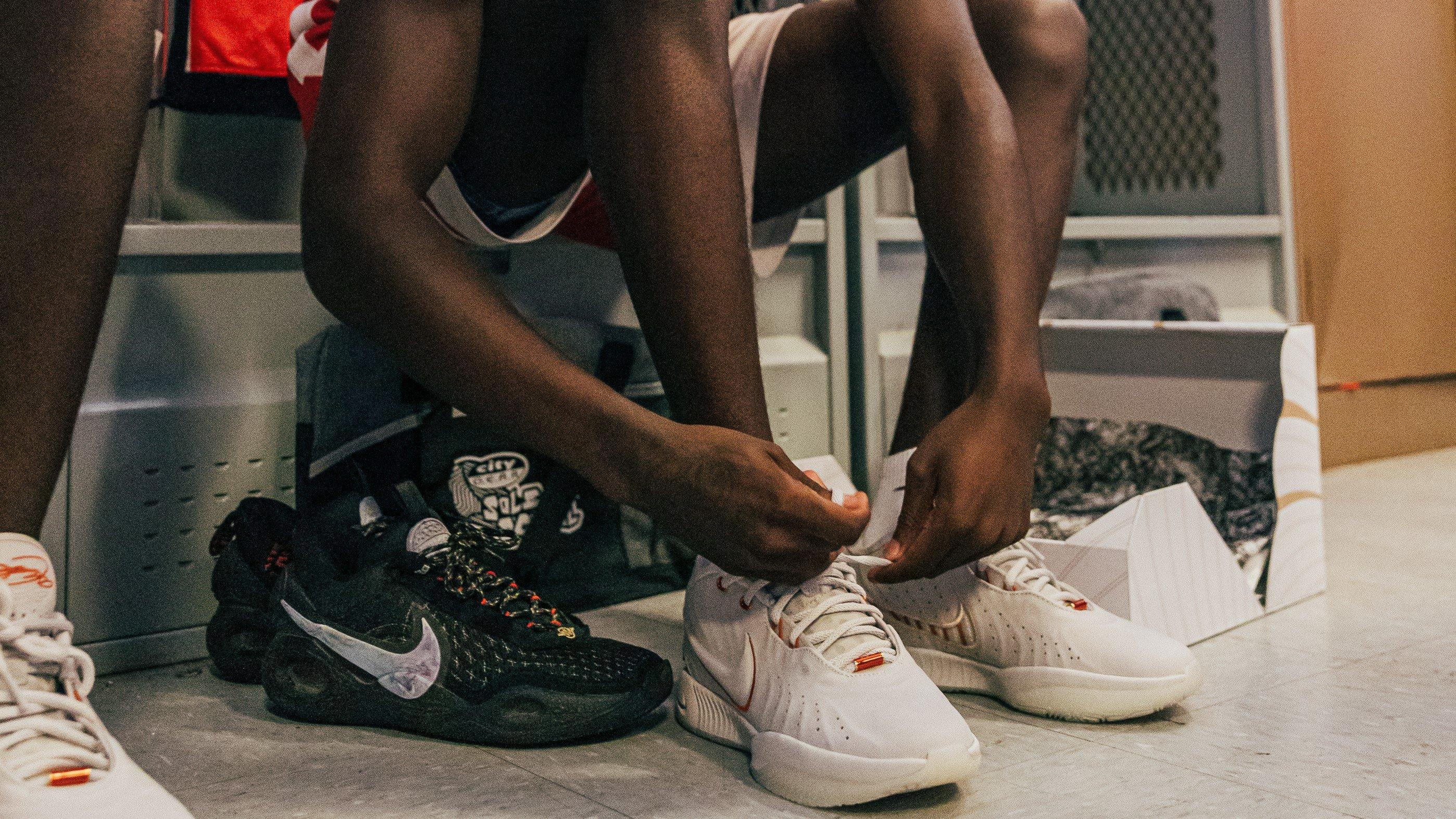 Provine High School basketball player tying new Nike LeBron 21 shoes