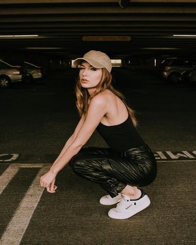 Woman modeling Reebok Club C 85 white sneakers