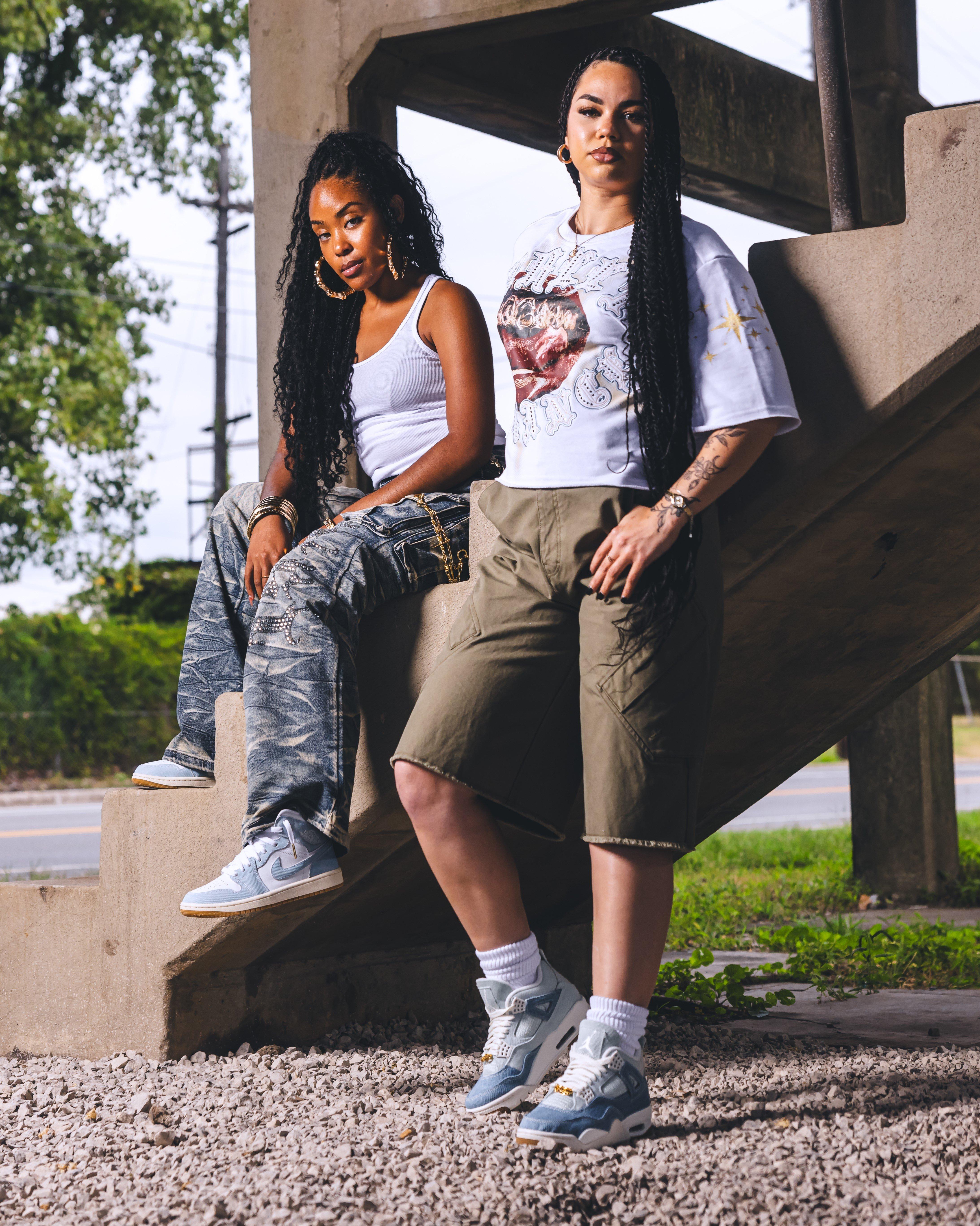 Women modeling Jordan 4 Retro "Worn Blue" Women's Shoe