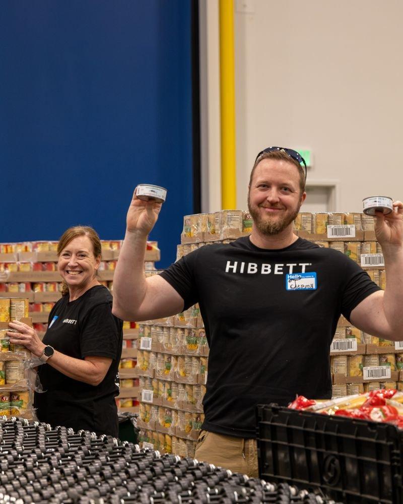 Hibbett teammates volunteer at a community service event, helping pack food boxes to support families in Central Alabama.