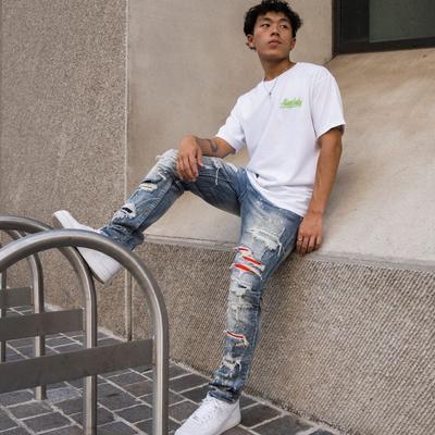 Distressed mid-wash skinny jeans on body