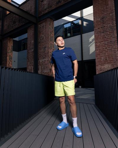 Young man modeling Nike Club Tee’s and Nike Calm Slides 