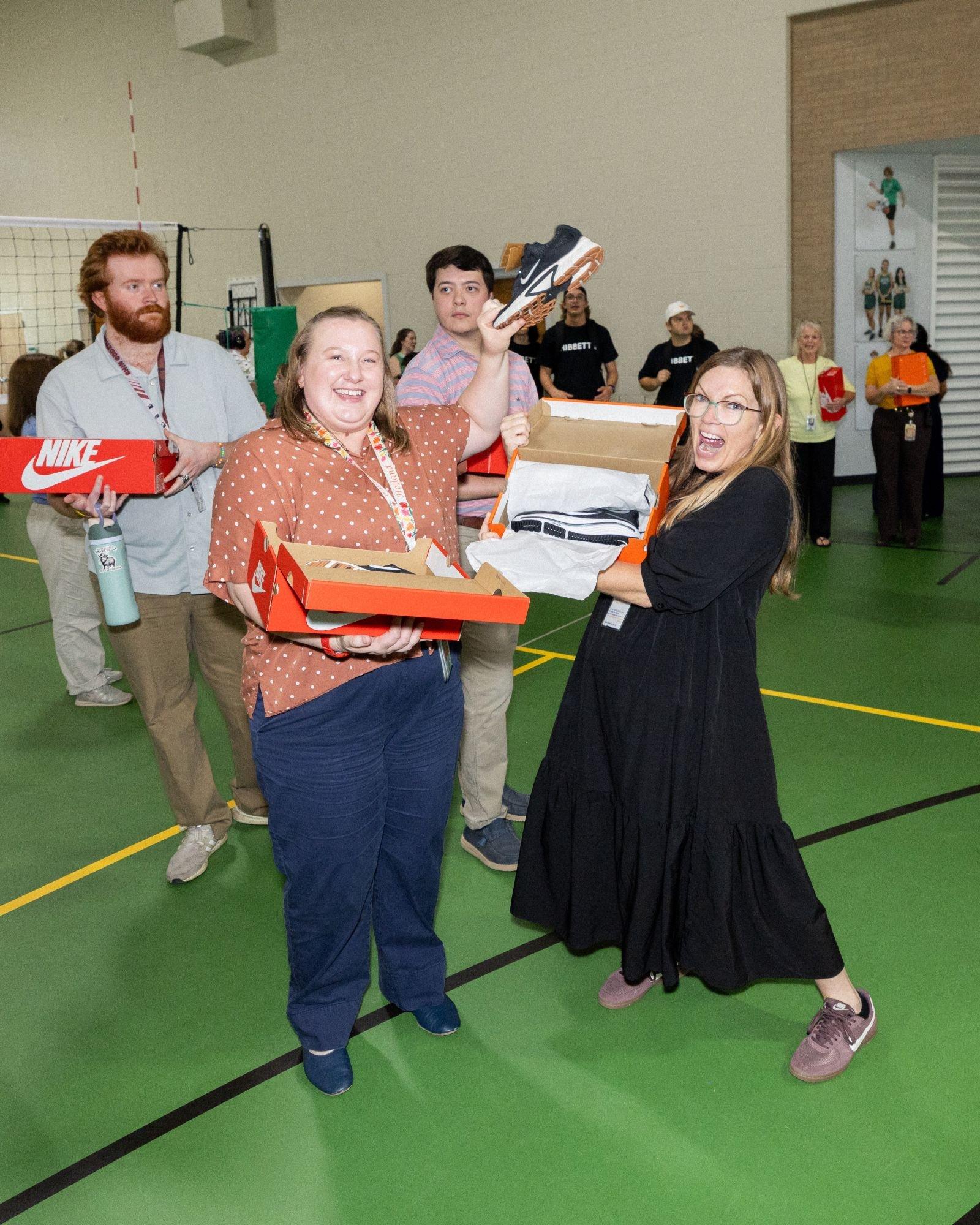 Spring Valley School faculty members receive Nike shoes during a Hibbett and Nike community celebration event.