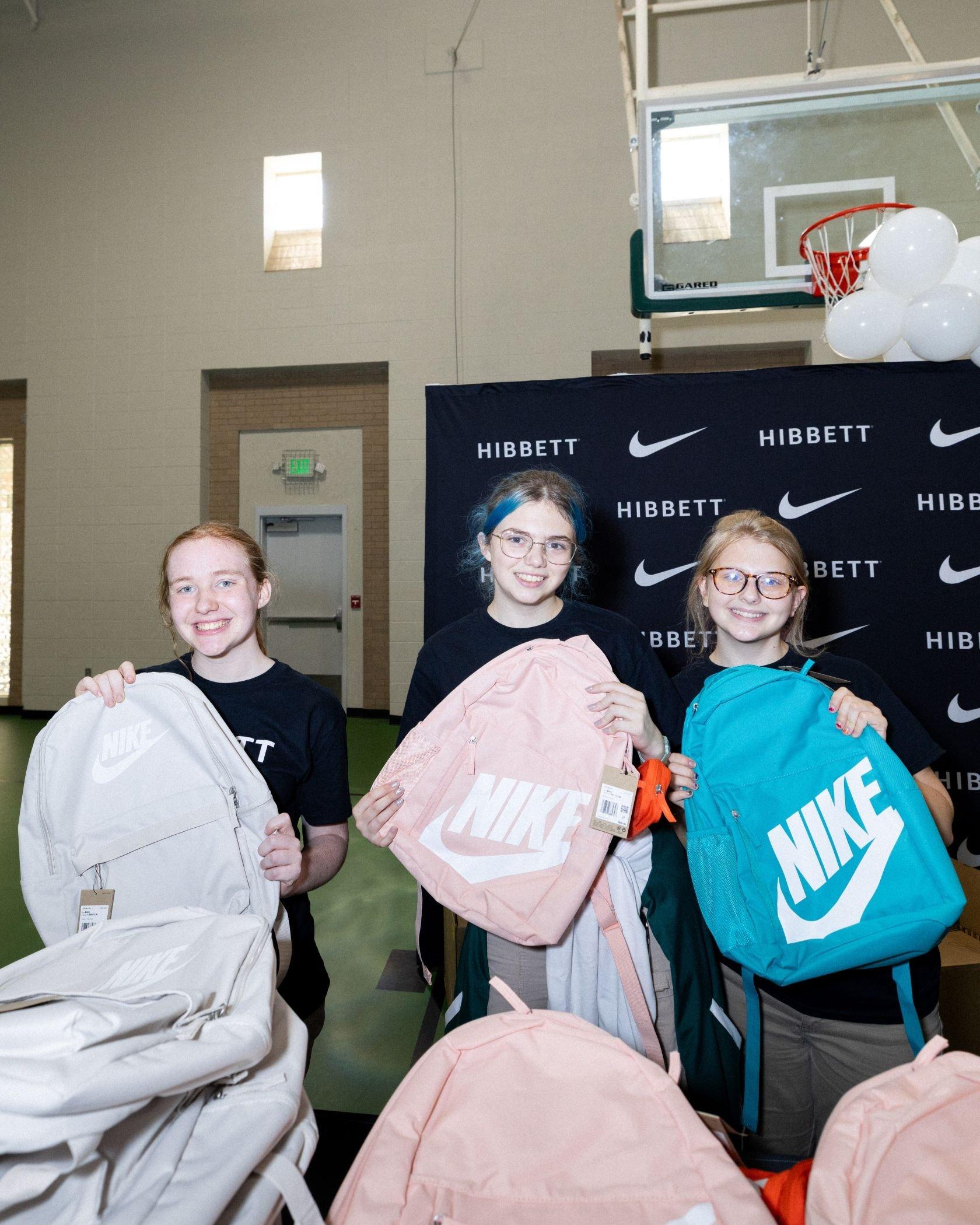 Spring Valley School students display Nike backpacks received during a Hibbett and Nike school celebration event.