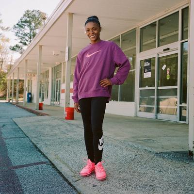 Anniston, Alabama's Amari Fleming posing in Nike women's apparel and Vapormax sneakers