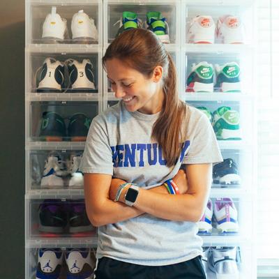 Chelsea posing in front of collection wall