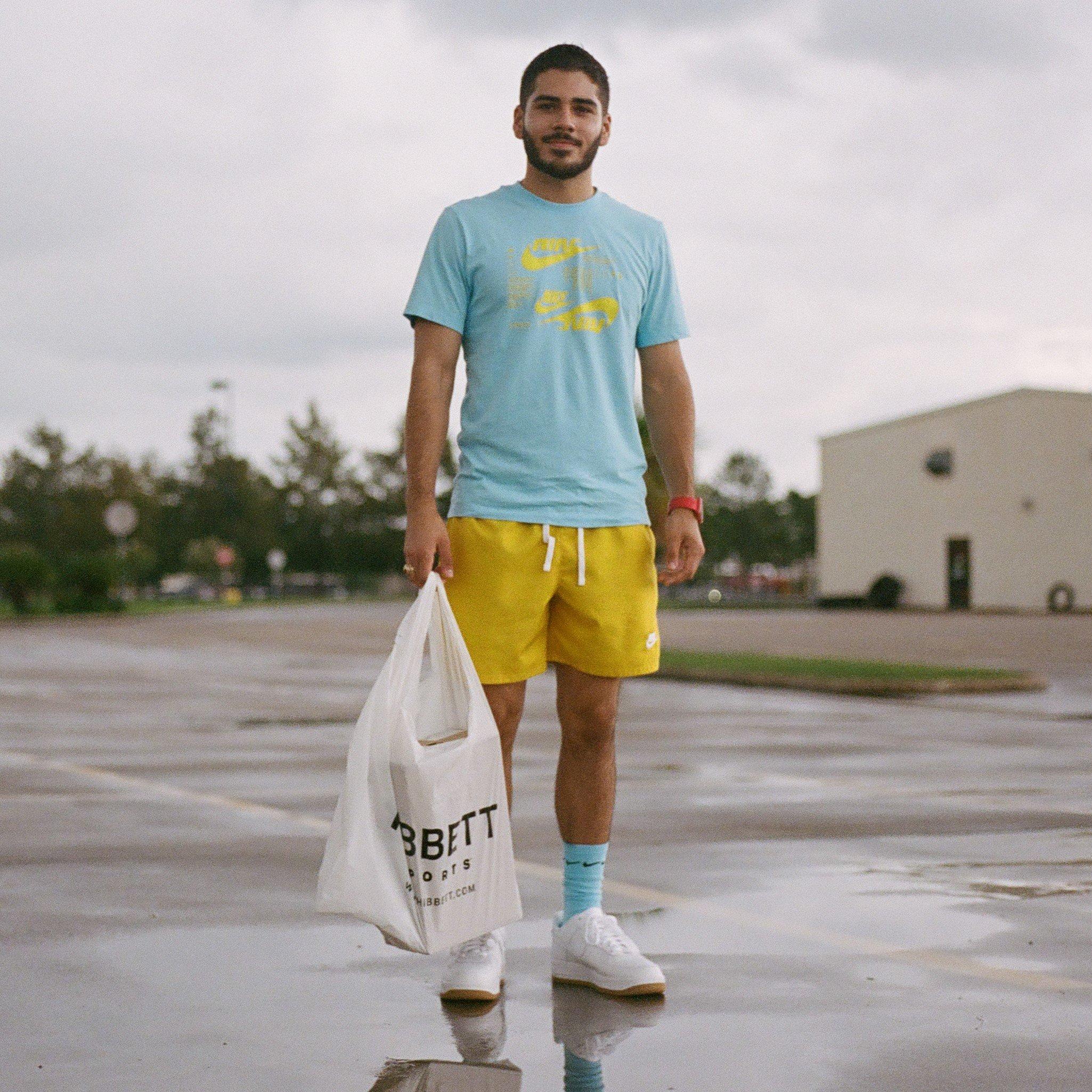 Gabe posing with Hibbett shopping bag
