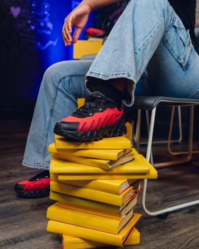Student with sneaker on books at RWAR headquarters