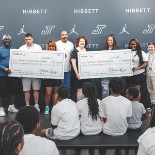 Representatives of the Whol's Center and Jayson Tatum Foundation accepting $50,000 from Hibbett | City Gear