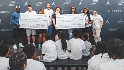 Representatives of the Whol's Center and Jayson Tatum Foundation accepting $50,000 from Hibbett | City Gear