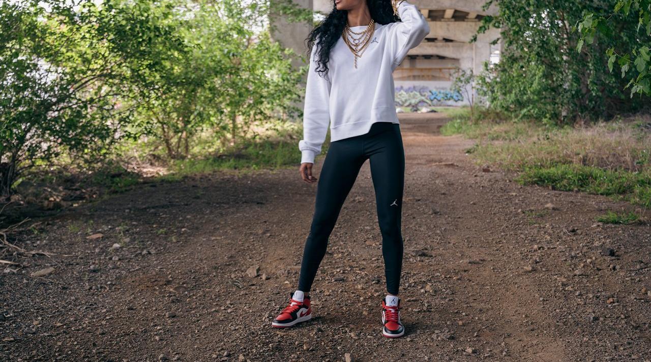 Girl standing Jordan 1 Mid "Bred" Black/Gym Red/White Women's Shoe