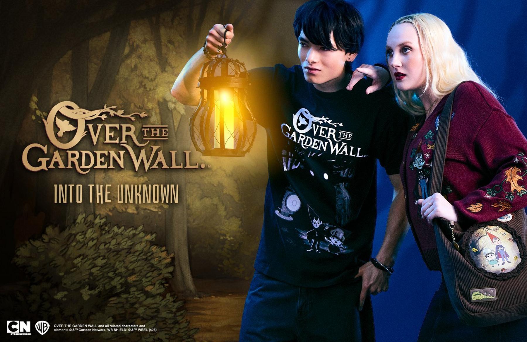 Two people wearing Over the Garden Wall apparel, holding a lantern and looking ahead. Shop Now.