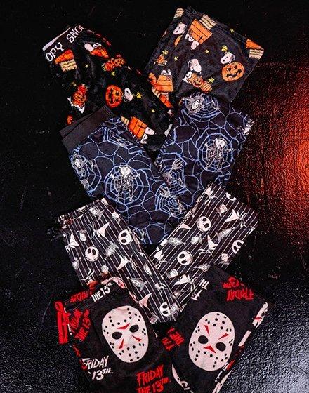 Four pairs of Halloween-themed pajamas with spiderweb, skull and Friday the 13th designs. Shop Now.