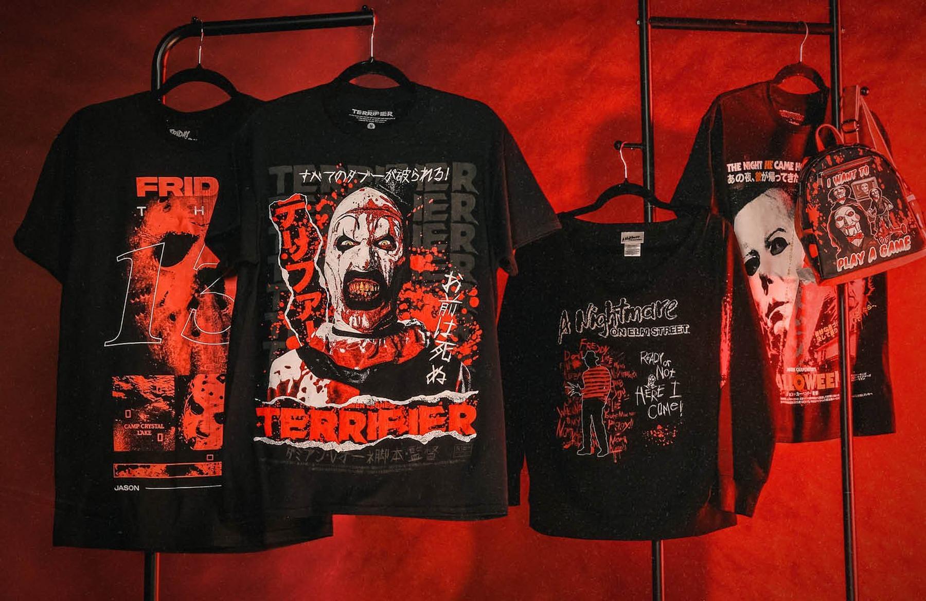 Four horror graphic T-shirts on hangers, including Terrifier, Friday the 13th, and Halloween prints. Shop Now.