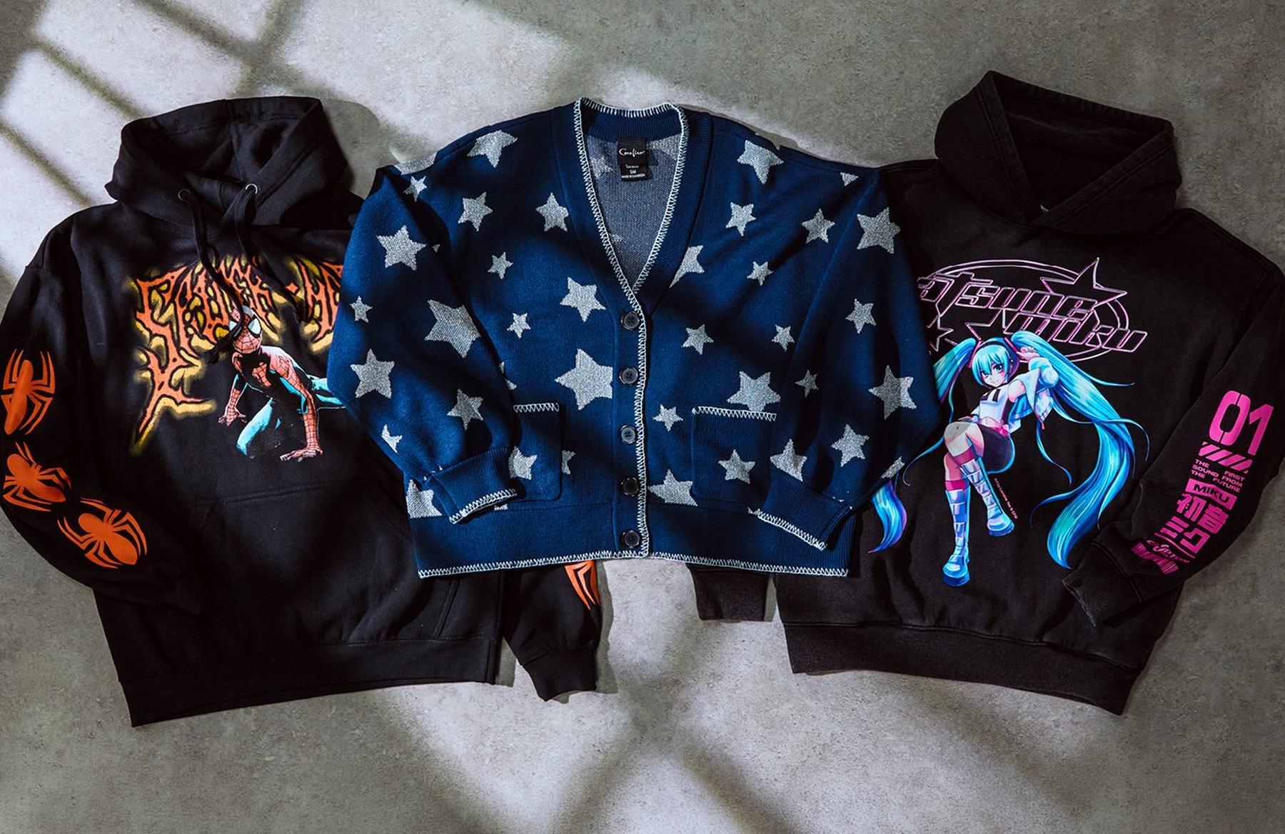 Three hoodies laid flat: spider graphic, star-pattern cardigan, and anime character hoodie. Shop Now.