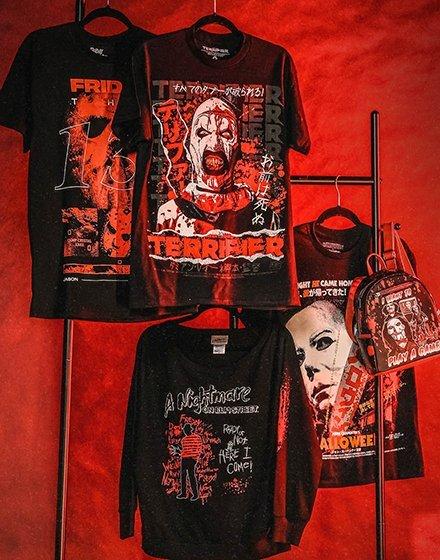 Four black horror graphic shirts on hangers, plus a matching backpack. Shop Now.