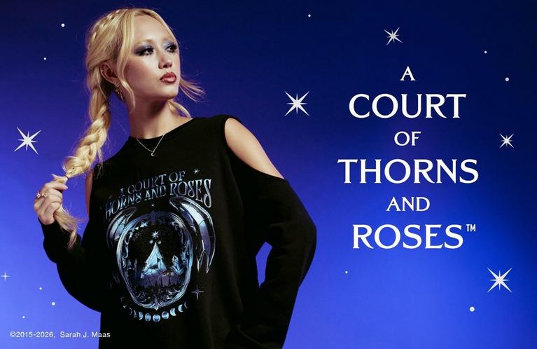 Model wearing black cold-shoulder sweatshirt with “A Court of Thorns and Roses” graphic. Shop Now.