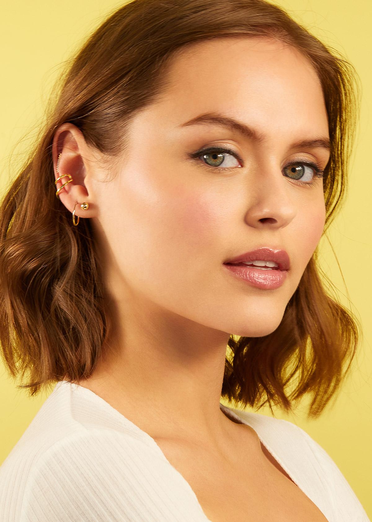 Woman wearing gold earrings