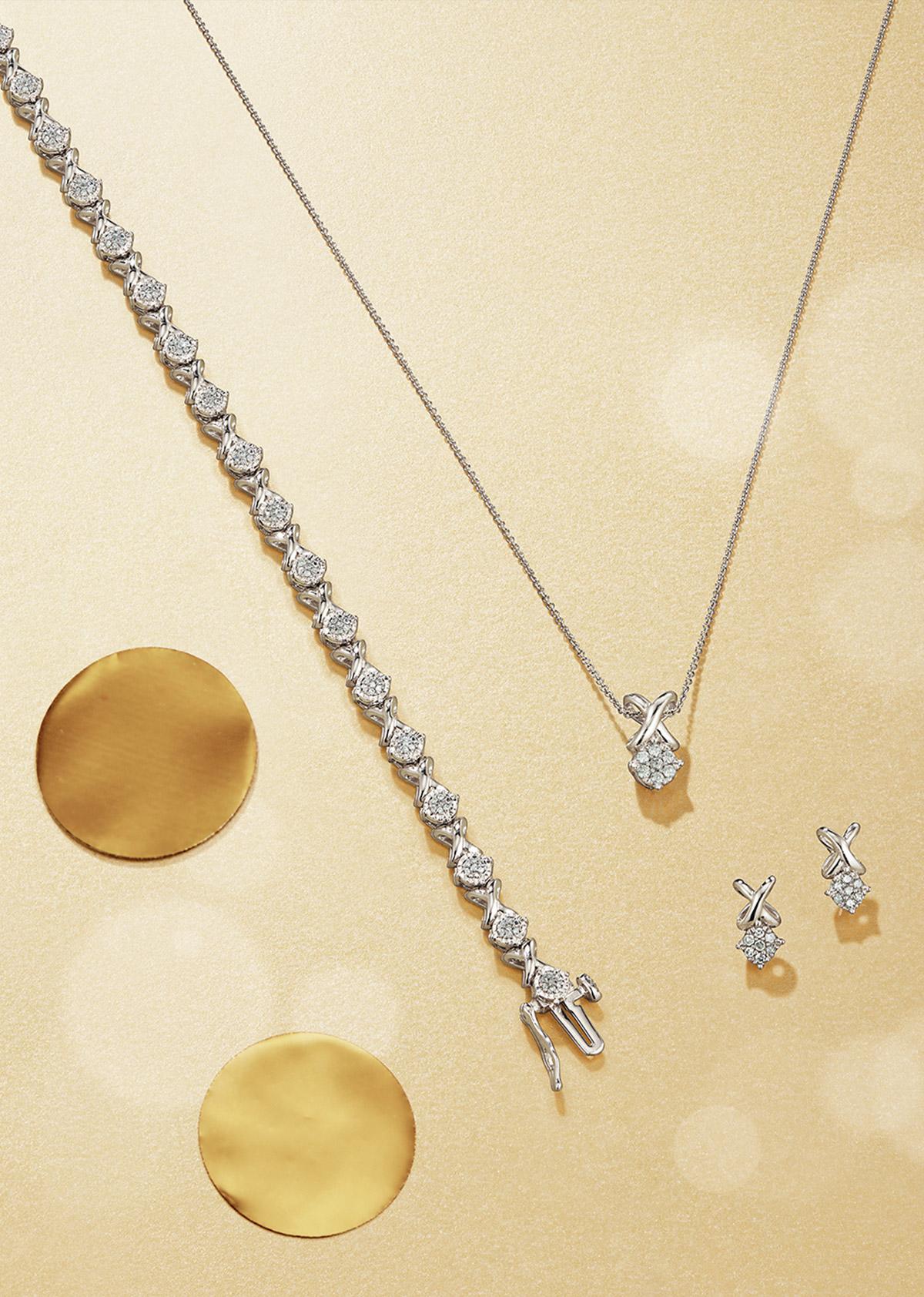 Diamond tennis bracelet, diamond pendant and earrings