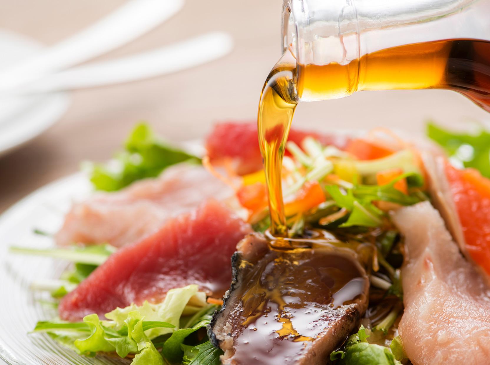 Japanese condiments drizzled over sashimi salad