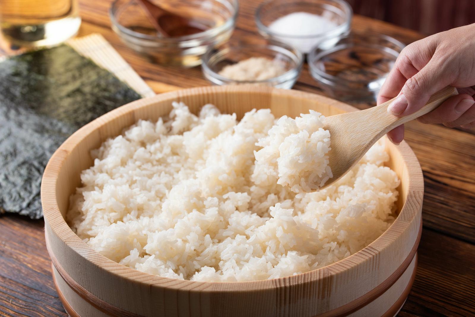 Sushi rice in a traditional wooden sushi rice mixing tub