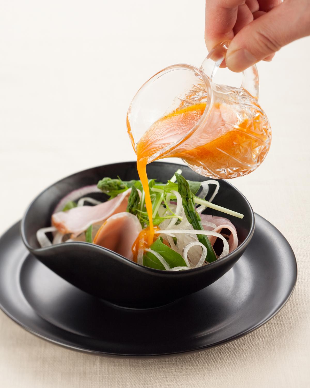 Miso dressing drizzled over a bowl of salad