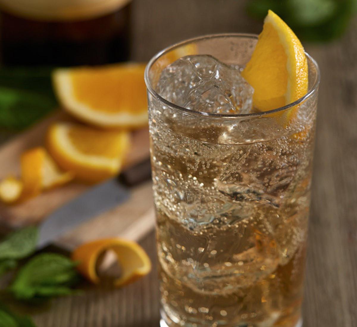 A cocktail garnished with a lemon wedge