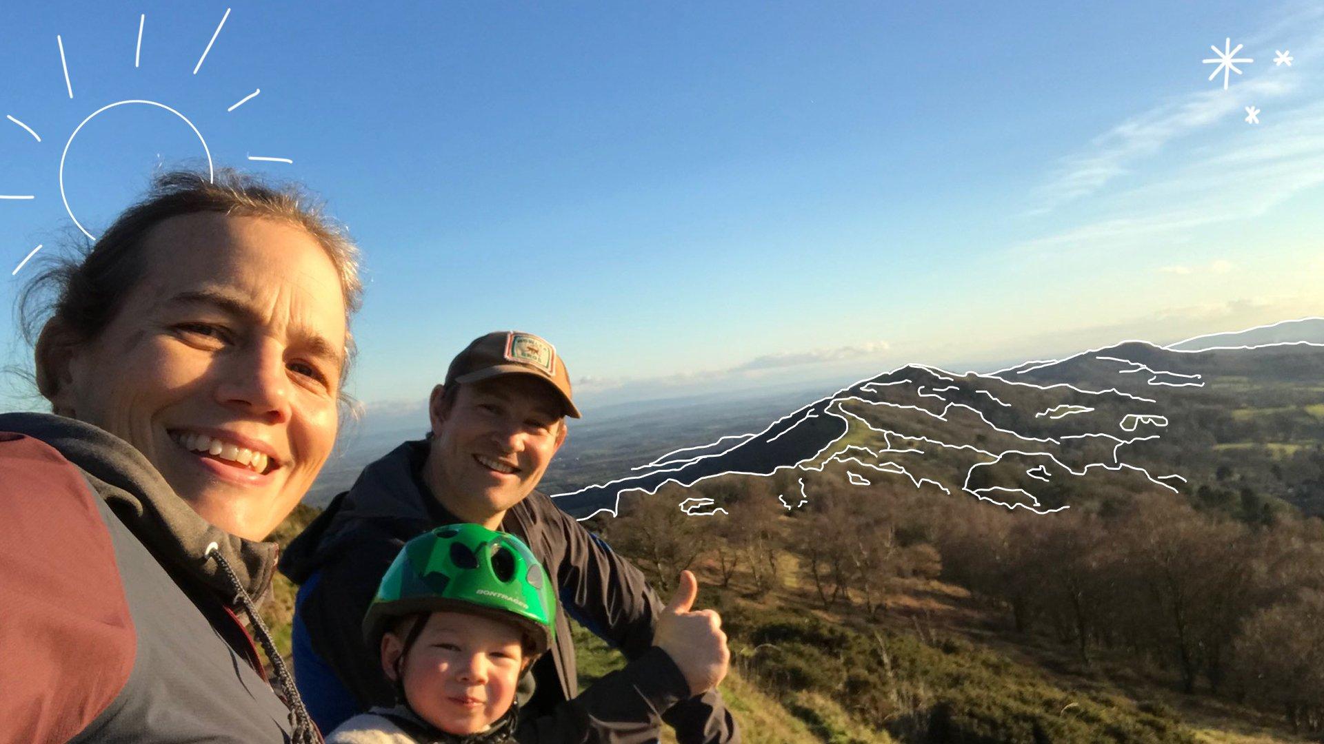 Tracy, Toby and her husband sat on a mountain