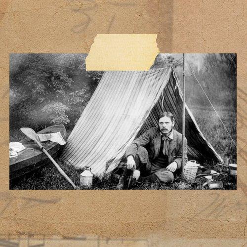 An image of Thomas Hiram Holding sat outside a tent outdoors.